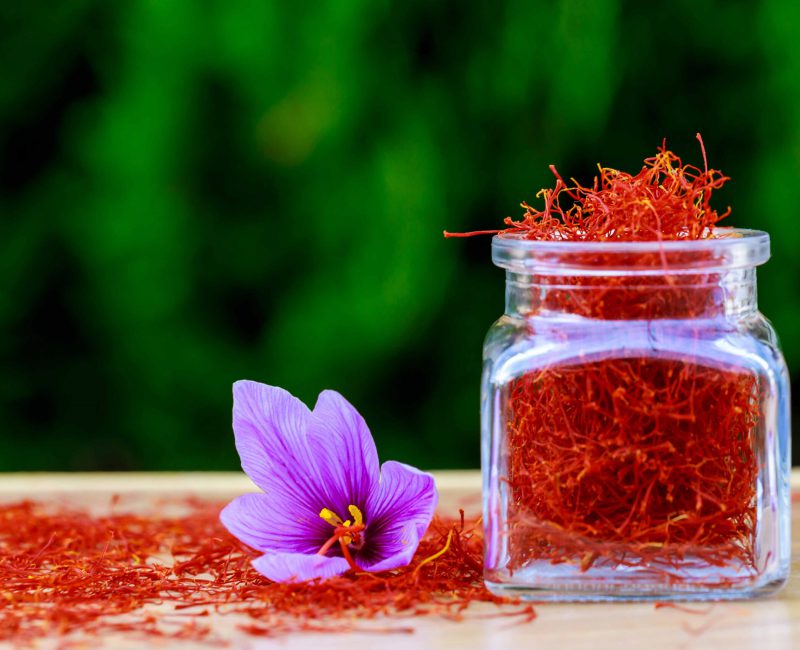 Dried,Saffron,Spices,In,A,Bottle,And,Saffron,Flower,On